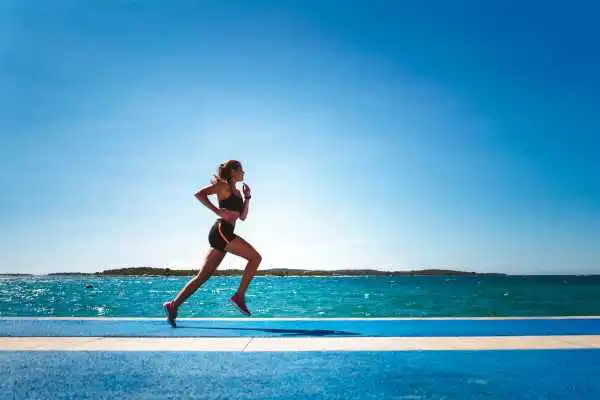 Woman running showing strong leg muscle Maidenhead